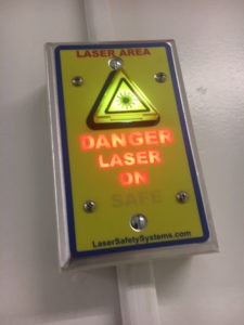 Danger, laser on! A warning sign cautions people not to enter the room when the microscope is on.