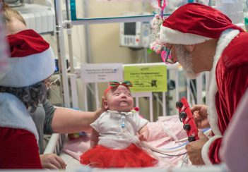 Dr. Robert Sinkin, dressed as Santa, makes his annual visit to the NICU.