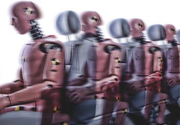 A blurry image of crash-test dummies used in car safety testing.