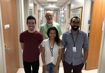 PhD students from Brazil stand in a hallway at the School of Medicine.