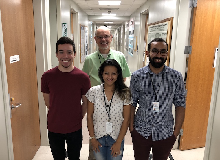 PhD students from Brazil stand in a hallway at the School of Medicine.
