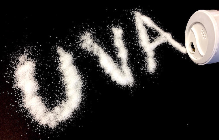 Salt has been used to spell out UVA on a black background.
