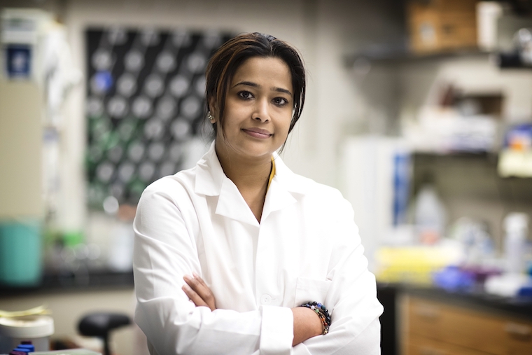Sanchita Bhatnagar stands with arms crossed in her lab.
