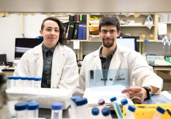 Former grad student Dorian A Rosen and Alban Gaultier sit at a lab bench.