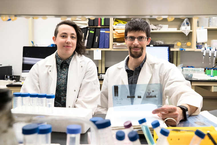 Former grad student Dorian A Rosen and Alban Gaultier sit at a lab bench.