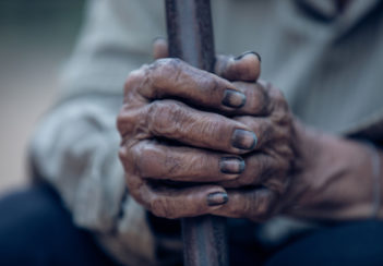 This is a closeup of a man's hands blackened by coal dust.