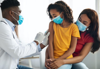 A young girl receives a vaccine.