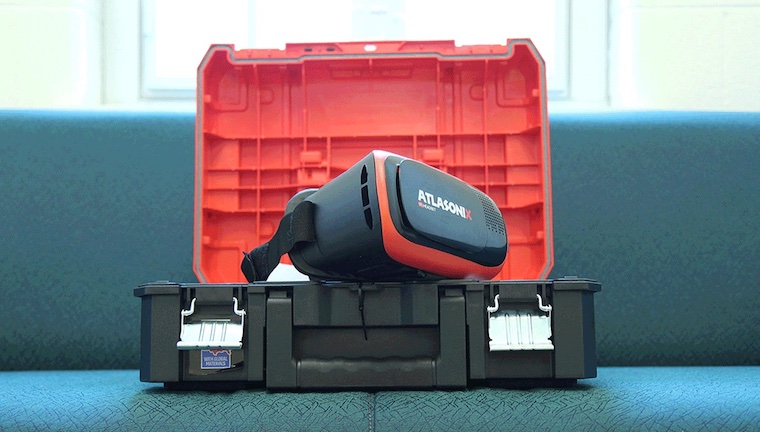 A virtual-reality headset sitting on a plastic storage box.